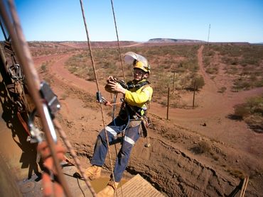 A man working at heights with safety gear.